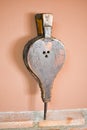 close up of an old bellows made in leather and wood. The bellows in vertical position is rested on a wall of bricks and an a brown Royalty Free Stock Photo