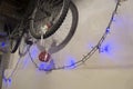 Close-up old bicycle hanging on the wall with Christmas lights Royalty Free Stock Photo