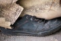 Close-up of an old black sneaker. Discarded shoes. Selective focus