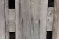 Close-up of an old board nailed down with two nails. Rusty nails, old textured boards, part of a fence. Horizontal photo