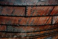 Close up of an old boat side with tared overlapped boards riveted together Royalty Free Stock Photo