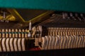 Close up of old broken dusty piano from the inside. Hammers in abandoned piano striking strings. Music playing from the ancient Royalty Free Stock Photo