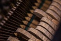 Close up of old broken dusty piano from the inside. Hammers in abandoned piano striking strings. Music playing from the ancient Royalty Free Stock Photo