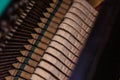 Close up of old broken dusty piano from the inside. Hammers in abandoned piano striking strings. Music playing from the ancient Royalty Free Stock Photo