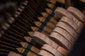 Close up of old broken dusty piano from the inside. Hammers in abandoned piano striking strings. Music playing from the ancient Royalty Free Stock Photo