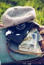 Close-up of an old camera with a vintage hat and retro photos on a wooden background