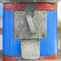 Close-up old candy machine, RUSTY METAL and blue and red painted