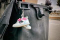 Close-up of old children\'s sports shoes hanging on a trash can Royalty Free Stock Photo