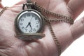 Close up of old clock on hand, deadline concept. Royalty Free Stock Photo