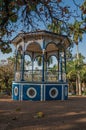 Close-up of an old colorful gazebo in the middle of verdant garden full of trees, in a sunny day at SÃÂ£o Manuel.