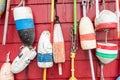 Weathered fishing buoy hanging on a wooden wall Royalty Free Stock Photo