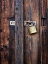 Old dark brown wooden door with padlock. Royalty Free Stock Photo