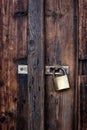 Old dark brown wooden door with padlock. Royalty Free Stock Photo