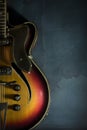 Close-up of old electric jazz guitar on a dark blue background Royalty Free Stock Photo
