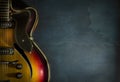 Close-up of old electric jazz guitar on a dark blue background