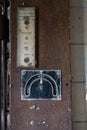 an old electric meter is exposed, inside a building with lots of rust Royalty Free Stock Photo
