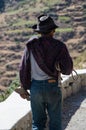 Close-up of old farmer with hat walking with a knife