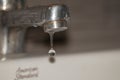 Close up old faucet with water drop background.