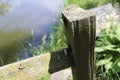 Close-up of old Fence post in Front of water