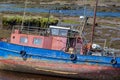 Close up of a old fishing boat in Clifden Bay at low tid