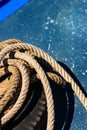 Close-up the old frayed boat rope on blue texture background