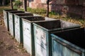 Close-up of old garbage containers in abandoned place.