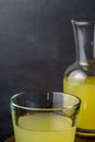 close-up of old glass and bottle with lemonade, with selective focus, gray background