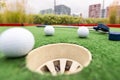 Close up, Old golf balls and putter on artificial grass for practice. Royalty Free Stock Photo