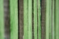 Close-up old green wooden fence with copy space. Wall of frayed wooden planks. Texture of old wooden planks with peeling paint. Royalty Free Stock Photo