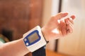 Close up of old hand with digital blood pressure monitor. Royalty Free Stock Photo