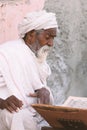 Close up of an old indian sadhu reading scriptures.