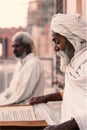 Close up of a old indian sadhu reading scriptures. Royalty Free Stock Photo