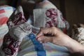 Close up of old lady hands darning winter socks with hole. Poverty in world economic crisis concept Royalty Free Stock Photo