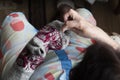 Close up of old lady hands darning winter socks with hole. Poverty in world economic crisis concept