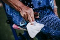 Close up of old lady hands holding a stick and protective mask outdoors. new normal Royalty Free Stock Photo