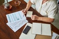 Elderly woman filling out taxes form at home Royalty Free Stock Photo