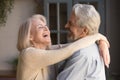 Close up image happy elderly spouses embracing standing indoors Royalty Free Stock Photo