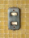 Close-up of old light switch on yellow mosaic wall as modern technology concept, in contrast Royalty Free Stock Photo