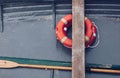 close up of a old little boat with buoy orange - life ring - marine mood. Royalty Free Stock Photo