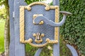 Close-up of an old lock with its handle on a wrought iron gate at the entrance to a park Royalty Free Stock Photo