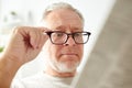 Close up of old man in glasses reading newspaper Royalty Free Stock Photo
