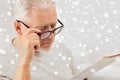 Close up of old man in glasses reading newspaper Royalty Free Stock Photo