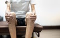 Close up of old man hand holding on the knee with suffering from knee pain. The sick legs of an old man with severely deformed Royalty Free Stock Photo