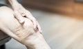 Close up of old man hand holding on the knee with suffering from knee pain. The sick legs of an old man with severely deformed Royalty Free Stock Photo