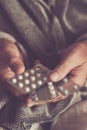 Close up of old man hands with mix of pills medicine to take to heal health. Concept of senior people health lifestyle with Royalty Free Stock Photo