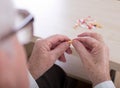 Close up of old man holding capsule Royalty Free Stock Photo