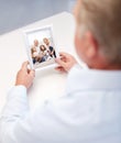 Close up of old man holding happy family photo