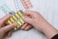 Close up of old man holding tablet of pill Royalty Free Stock Photo