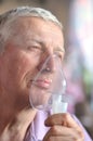 Old man with an inhaler Royalty Free Stock Photo