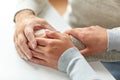 Close up of old man and young woman holding hands Royalty Free Stock Photo